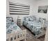 Bedroom with twin and full beds, featuring coastal decor at 6104 Palma Del Mar S Blvd # 104, St Petersburg, FL 33715