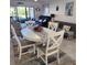 Dining area with white table and chairs, situated near the living room and kitchen at 6104 Palma Del Mar S Blvd # 104, St Petersburg, FL 33715