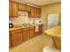 Simple kitchen with wood cabinets and appliances at 6104 Palma Del Mar S Blvd # 104, St Petersburg, FL 33715