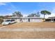 Ranch style home with a large front yard and driveway at 7143 Pear Ln, Spring Hill, FL 34606