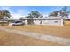 One-story house with a minivan parked in front at 7143 Pear Ln, Spring Hill, FL 34606