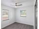 Bright bedroom with gray flooring, neutral walls, and ceiling fan at 8704 Temple Park Dr, Tampa, FL 33637