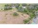 Overgrown lot with a house and surrounding trees at 10809 Bartolotti Loop, Seffner, FL 33584