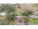 House with damaged roof and surrounding trees at 10809 Bartolotti Loop, Seffner, FL 33584