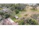 House with damaged roof and surrounding trees at 10809 Bartolotti Loop, Seffner, FL 33584