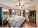 Spacious primary bedroom with a king-size bed and large windows at 10809 Bartolotti Loop, Seffner, FL 33584