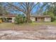 Ranch-style home with carport and mature landscaping at 10809 Bartolotti Loop, Seffner, FL 33584