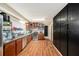 Galley kitchen with stainless steel appliances and wood flooring at 10809 Bartolotti Loop, Seffner, FL 33584