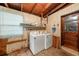 Functional laundry room with washer, dryer, and storage shelves at 10809 Bartolotti Loop, Seffner, FL 33584