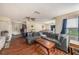 Open living area with L-shaped sofa and wood flooring at 10809 Bartolotti Loop, Seffner, FL 33584