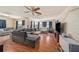 Spacious living area with L-shaped sofa and wood flooring at 10809 Bartolotti Loop, Seffner, FL 33584