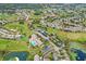 Aerial view of a golf course community with houses, tennis courts, and a clubhouse at 11021 Edge Park Dr, Hudson, FL 34667