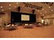 Large banquet hall with ample seating and a stage at 11021 Edge Park Dr, Hudson, FL 34667
