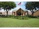 Community clubhouse with welcoming entrance and landscaping at 11021 Edge Park Dr, Hudson, FL 34667