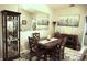 Elegant dining room with a wood table, four chairs, and decorative wall art at 11021 Edge Park Dr, Hudson, FL 34667