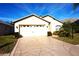 Front view of a single-story house with a white garage door at 11021 Edge Park Dr, Hudson, FL 34667