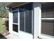 Exterior view of screened-in patio and window at 11021 Edge Park Dr, Hudson, FL 34667