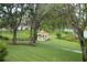 Scenic gazebo nestled in lush landscaping near a pond at 11021 Edge Park Dr, Hudson, FL 34667