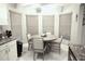 Breakfast nook in kitchen with round table and chairs near large windows at 11021 Edge Park Dr, Hudson, FL 34667