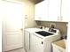 Laundry room with washer, dryer, and upper cabinets at 11021 Edge Park Dr, Hudson, FL 34667