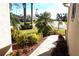 Well-maintained walkway through a side yard with tropical plants at 11021 Edge Park Dr, Hudson, FL 34667