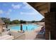 Community swimming pool with lounge chairs and people swimming at 11021 Edge Park Dr, Hudson, FL 34667