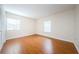 Spacious bedroom with wood flooring and two windows with blinds at 11805 Northtrail Ave, Temple Terrace, FL 33617
