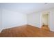 Bright bedroom featuring hardwood floors and access to bathroom at 11805 Northtrail Ave, Temple Terrace, FL 33617