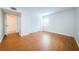 Bright bedroom featuring wood floors and a large closet at 11805 Northtrail Ave, Temple Terrace, FL 33617