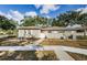 Tan single story home with white fence and walkway at 11805 Northtrail Ave, Temple Terrace, FL 33617