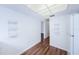 White kitchen with wood flooring and a hallway leading to other rooms at 11805 Northtrail Ave, Temple Terrace, FL 33617