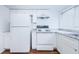 White kitchen with granite countertops and stainless steel appliances at 11805 Northtrail Ave, Temple Terrace, FL 33617