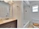 Clean bathroom with tub and dark brown vanity at 1206 Meadowcrest Dr, Valrico, FL 33594