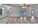 Bright dining room with vinyl flooring, view to pool, and access to kitchen at 1206 Meadowcrest Dr, Valrico, FL 33594