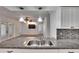 Modern kitchen with granite countertops and a double sink at 1206 Meadowcrest Dr, Valrico, FL 33594