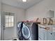 Laundry room with washer, dryer and water heater at 1206 Meadowcrest Dr, Valrico, FL 33594