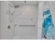 Walk-in shower with tiled walls and grab bar at 1206 Meadowcrest Dr, Valrico, FL 33594