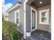 Front door entrance with a welcome sign and flowers at 13316 Wildgrass Trl, Odessa, FL 33556