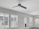 Living room with ceiling fan and plantation shutters at 13316 Wildgrass Trl, Odessa, FL 33556