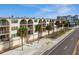 Beachfront building, featuring balconies and palm trees at 14001 Gulf Blvd # 304, Madeira Beach, FL 33708