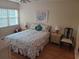 Bright bedroom with floral bedding and wood floors at 14130 Rosemary Ln # 6214, Largo, FL 33774