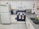 White kitchen with granite countertops and stainless steel appliances at 14130 Rosemary Ln # 6214, Largo, FL 33774