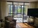 Living room with access to a screened lanai overlooking a canal at 14130 Rosemary Ln # 6214, Largo, FL 33774