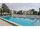 Community pool with ample lounge chairs at 14130 Rosemary Ln # 6214, Largo, FL 33774