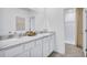 Double vanity bathroom with marble countertop and shower at 1500 Hammer Pl, Largo, FL 33774