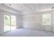 Unfinished bedroom with drywall and sliding glass door at 15084 Mcgraw Ave, Port Charlotte, FL 33953