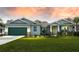 Craftsman style home with green garage door and stone accents at 15084 Mcgraw Ave, Port Charlotte, FL 33953