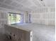 Open living area with drywall and sliding glass door at 15084 Mcgraw Ave, Port Charlotte, FL 33953