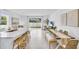 Open kitchen with large island, white cabinets, and breakfast bar at 1540 Hammer Pl, Largo, FL 33774