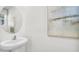 Small powder room with pedestal sink and modern decor at 1540 Hammer Pl, Largo, FL 33774